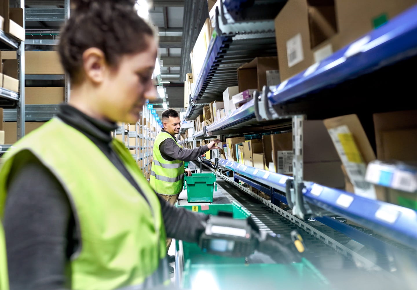 Two Cencora team members wearing yellow safety vests in our distribution center, showing our resilient and sustainable operations.