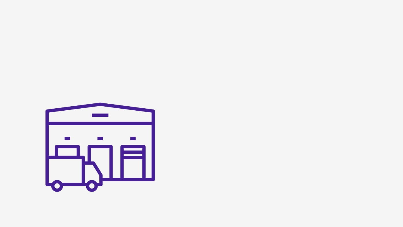 Icon depicting a truck driving in front of a warehouse.