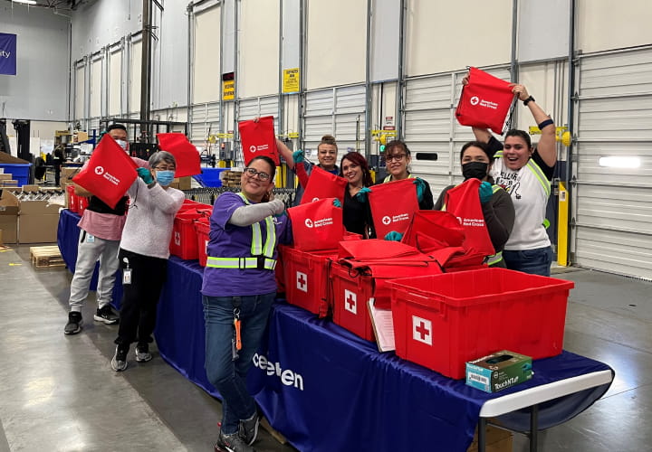 Eight Cencora employees in a warehouse packing hygiene kits for military veterans that were distributed in local communities through our Red Cross partnership.