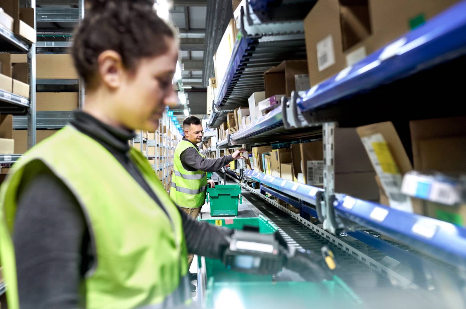 Two Cencora team members wearing yellow safety vests in our distribution center, showing our resilient and sustainable operations.